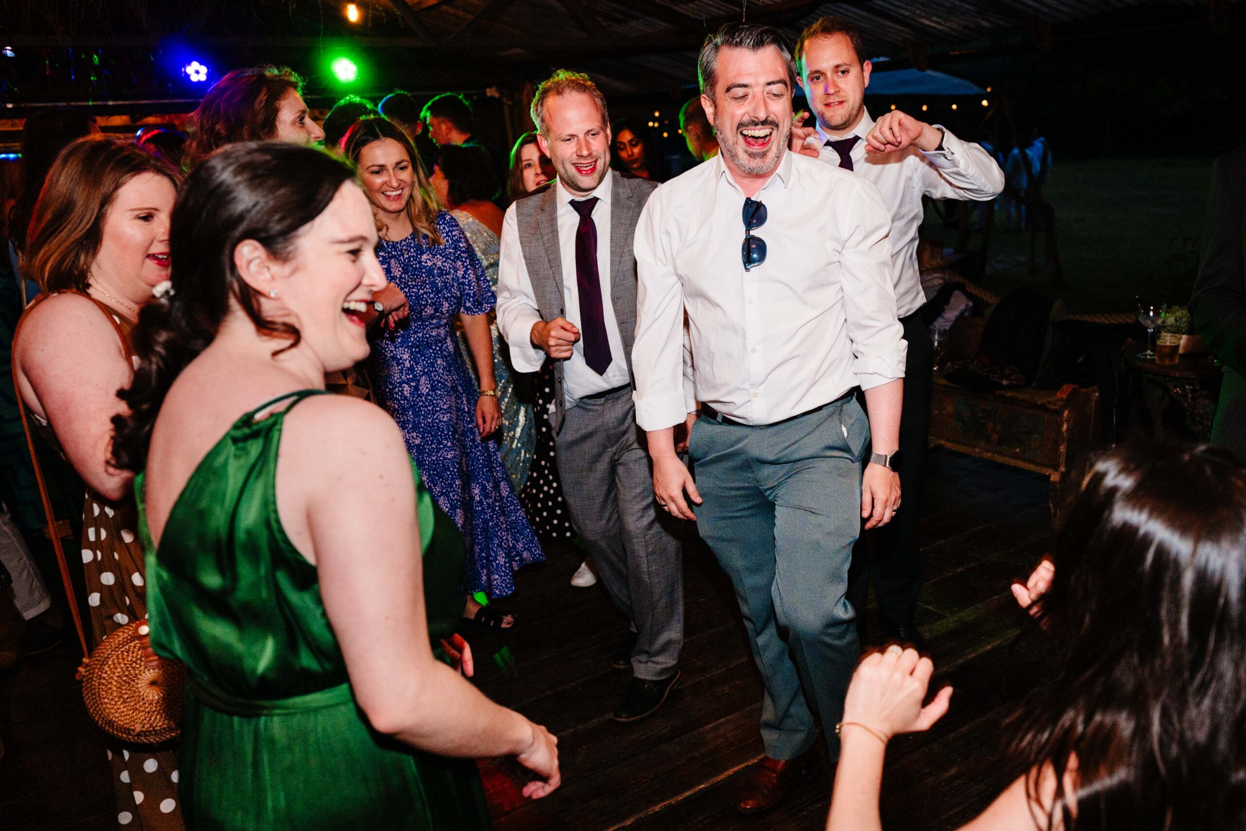 Wedding guests dancing and celebrating during the evening reception at The Dreys.