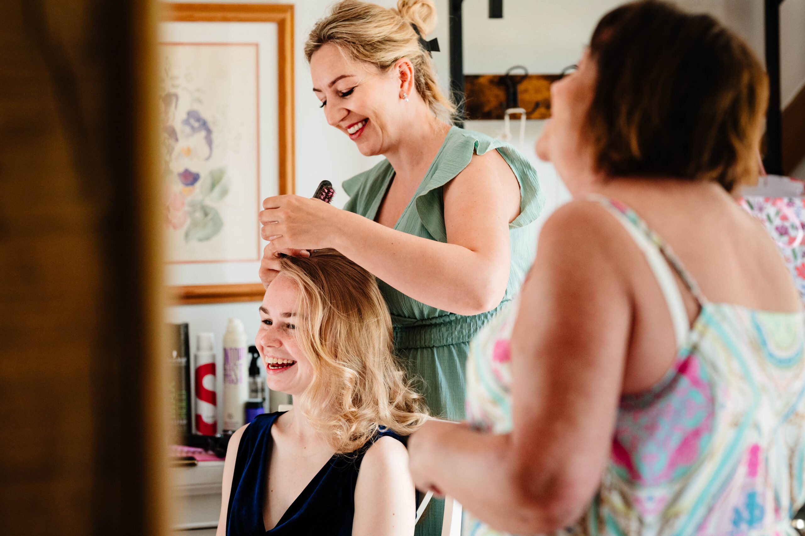 Bride having her hair styled during the morning preparations at The Dreys wedding venue.